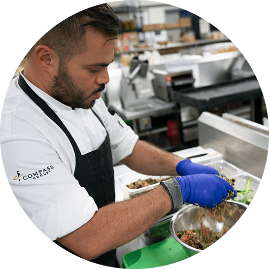 Chef mixing a salad in a kitchen