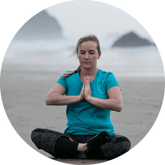 Woman sitting on the beach meditating