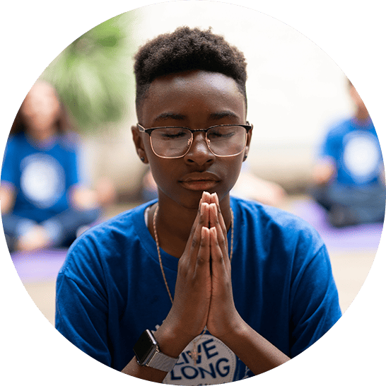 Young boy with hands in prayer