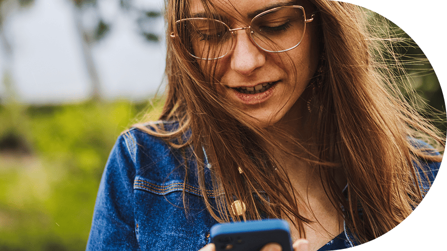 Woman outdoors looking at her phone