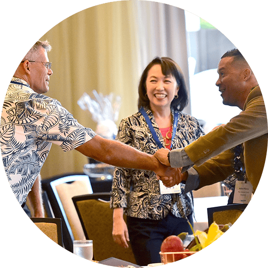Two men shaking hands at a conference