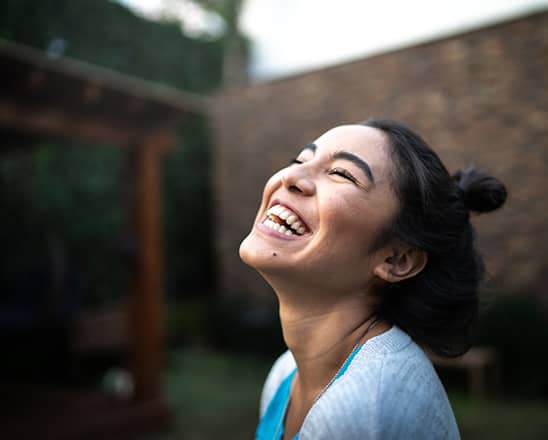 Young woman smiling looking toward the sun