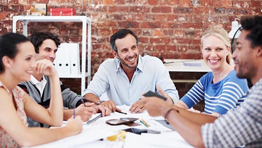 Employees sitting around a table