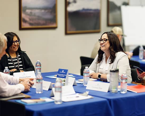 Adults talking at a table.