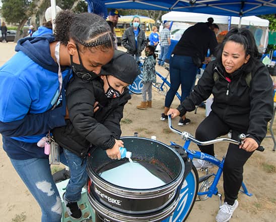 Community members making art with a bike.